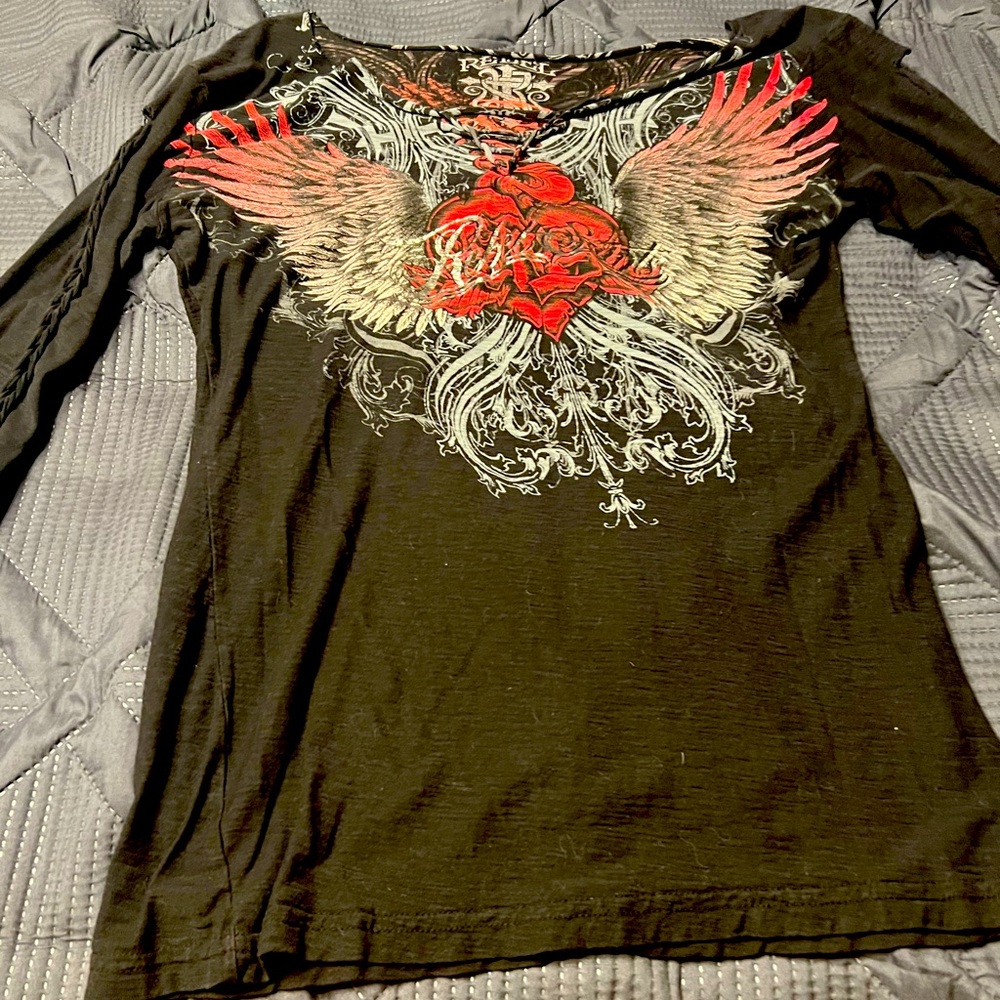 The brand is rebel is a black shirt with red heart on it it size large